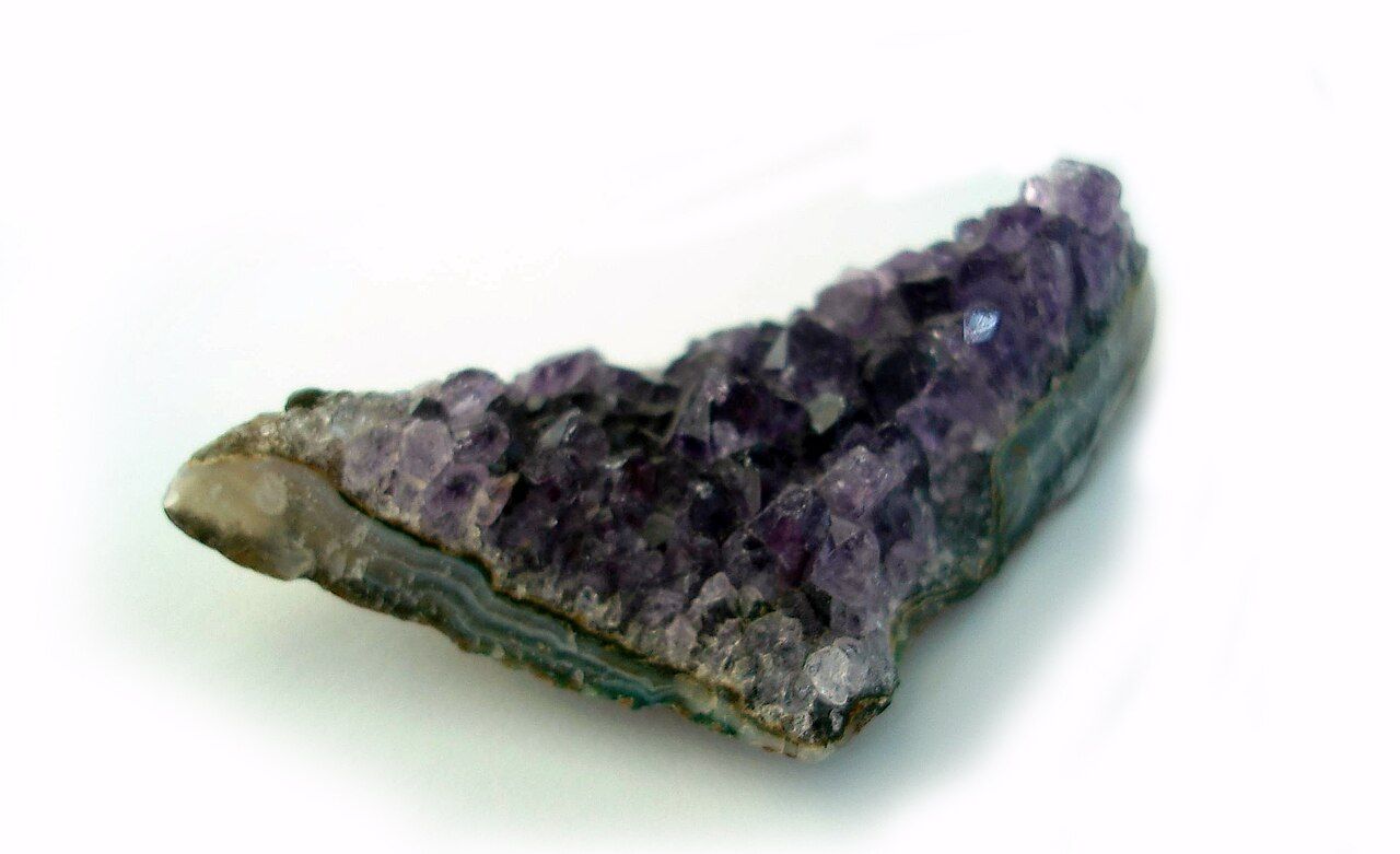 Before: A purple amethyst crystal on a white surface, shown first with the surface and then isolated on transparency